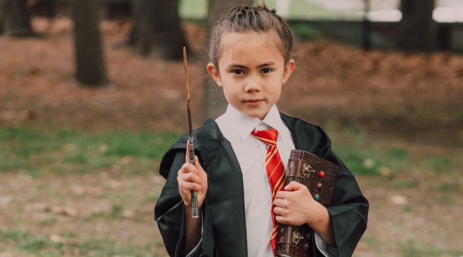 Clued Upp Games Review - Young girl in Harry Potter costume holding a wand and spell book